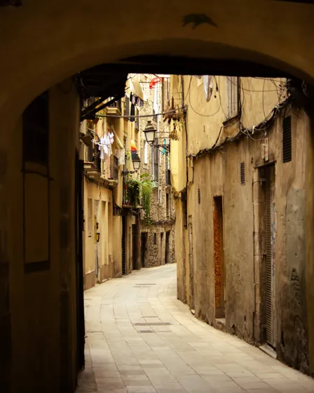 A stone passage in the old town, lit from the far end