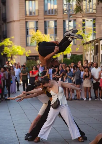 A street dancer mid-move in front of a crowd